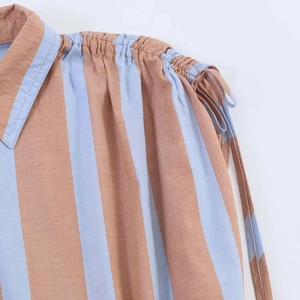 Macro detail of vertical stripes, cotton-linen texture and drawstring on sleeveless shirt