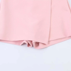 Detailed view of light pink skort hemline with high-quality stitching and fabric texture