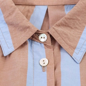Detail view showing brown and blue vertical stripes on breathable cotton linen fabric