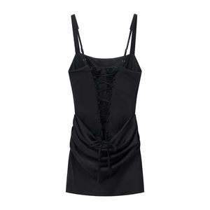Detail of sexy backless mini dress with criss-cross lace-up design and pleated waist