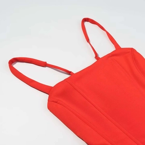 Close-up of a red corset dress with structured stitching and thin shoulder straps