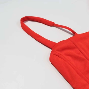 Close-up of a red strapless dress featuring structured corset boning and fine stitching