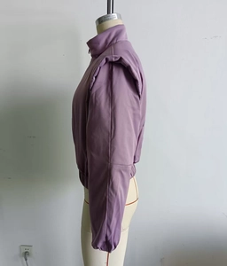 Side view of purple cropped bomber jacket with stand collar and padded shoulders
