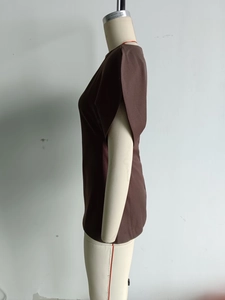 Detailed side view of dark brown puff sleeve top on mannequin showing fabric texture