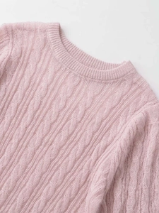 Close-up of pink cable knit texture on soft mohair blend crewneck sweater fabric