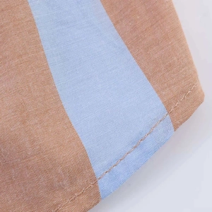 Detailed close-up of vertical striped fabric with neat stitching and woven texture