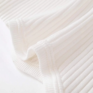 Close-up of white ribbed knit fabric with soft vertical texture and premium stitching