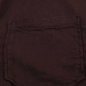 Detailed macro view of the dark brown linen fabric pocket with neat stitching details