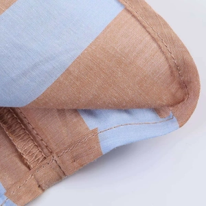 Detailed macro view of the blue and orange striped fabric showing fine stitching lines
