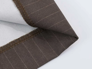 Detailed macro view of dark brown pinstripe fabric showing neat hemmed sewing craftsmanship