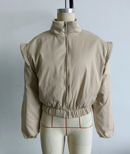Detail of beige stand collar bomber jacket with wide shoulders and elastic cuffs