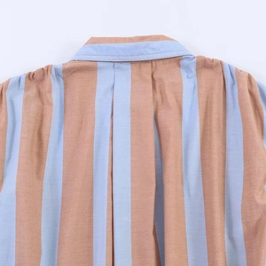 Detail shot of the vertical striped shirt collar and fabric texture in blue and khaki