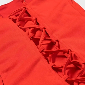 Close-up of lace-up corset detail on a vibrant red sexy mini dress for women
