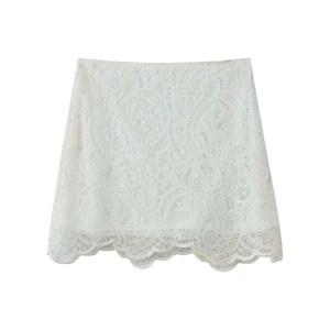 Detail of high-waist white lace mini skirt with intricate paisley embroidery and scalloped hem