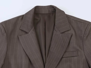 Detailed macro shot of brown pinstripe blazer notched lapel and fine fabric texture