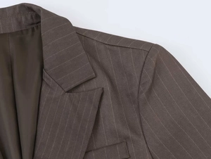 Detailed macro of the notched lapel and pinstripe fabric texture on brown blazer jacket