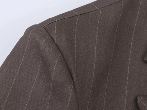 Macro view of brown striped blazer showing shoulder stitching and woven fabric texture