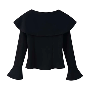 Detail of black off-shoulder top featuring large ruffle collar and elegant bell cuffs
