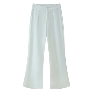 Detailed view of the pleated waist and clean drape of white wide-leg trousers