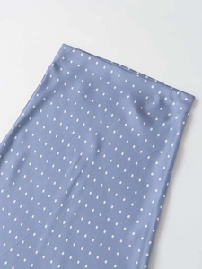 Detail of lavender polka dot satin skirt fabric texture and smooth glossy finish