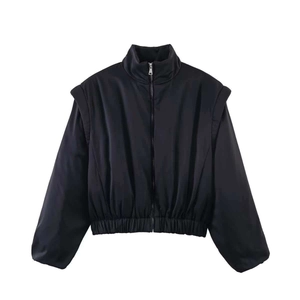Detail of black stand collar jacket with layered shoulder silhouette and satin-like finish