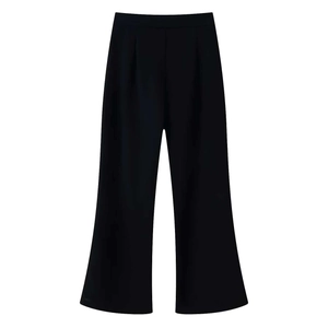 Detail of high-waist black wide-leg trousers with elegant drape and pleat features