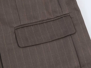 Detail of the flap pocket and fine vertical stripes on a brown tailored blazer jacket