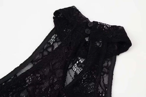 Close-up of black lace halter neck detail with back button closure on the dress