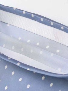 Detail of blue polka dot satin skirt with elastic waistband and high-quality stitching