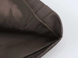 Close-up showing the high-quality fabric texture and inner lining of a brown blazer suit