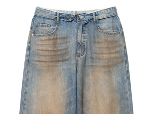 Detail of vintage blue denim jeans with whiskering effect and classic five-pocket design