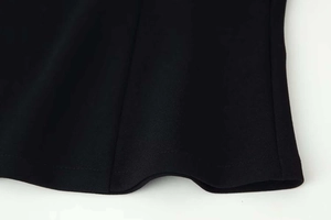 Macro detail of high-quality black fabric texture and neat single-needle hem stitching