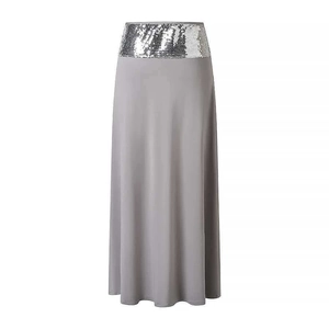 Detail view of a gray maxi skirt featuring a shimmering silver sequined waistband