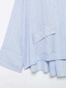Close-up of light blue striped shirt featuring a large flap pocket and sleeve detail