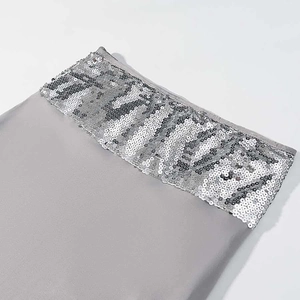 Detail of silver sequins sewn on grey chiffon fabric with high quality metallic reflection