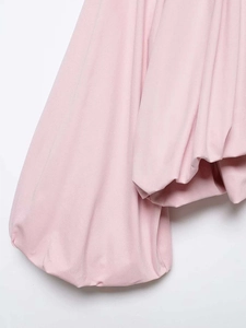 Detailed close-up of pink puff sleeves and textured fabric on this stylish women blouse