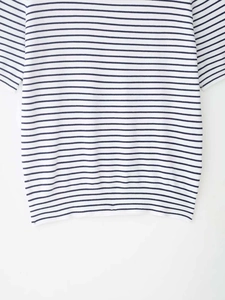 Close-up of blue and white striped knit shirt showing the ribbed hem and soft fabric texture