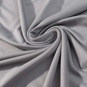 Close-up detail of silver-grey sequined knit fabric with satin luster and elegant drape