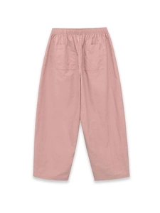 Detail view of pink wide-leg pants featuring an elastic waist and dual back pockets