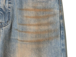 Detailed macro shot of vintage dirty wash denim with whiskering on light blue jeans