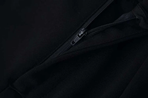 Macro shot of matte black zipper and high-quality fabric texture on the jumpsuit