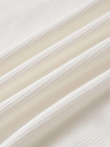 Detailed close-up of white ribbed fabric texture with soft vertical grain for women's T-shirt