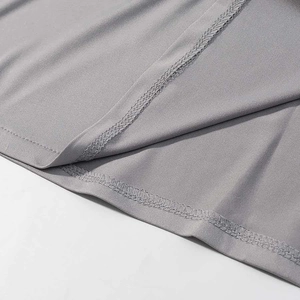 Macro shot of breathable grey quick-dry fabric showing fine double-stitch hem details