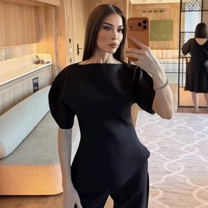 Elegant black off-shoulder puff sleeve top and matching slim trousers set for women