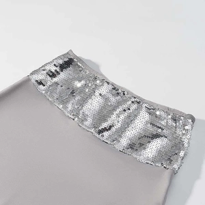 Detail of silver sequin trim on grey sleeveless top and maxi skirt two-piece set