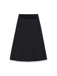 Detail shot of black satin skirt featuring a wide floral lace waistband and A-line silhouette