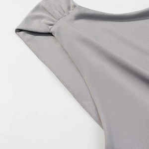 Detailed macro view of gray sleeveless top featuring ruched shoulder pleats and soft fabric