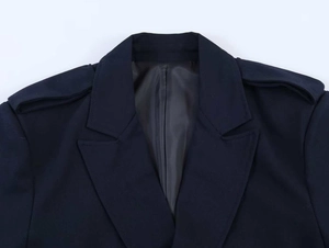 Detailed view of the notch lapel and shoulder straps on this navy blue blazer jacket
