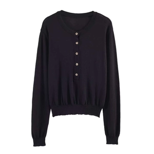 Slim fit black long sleeve knit top with decorative front buttons and ribbed cuffs