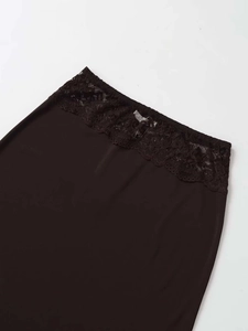 Detail of the elegant lace waistband on a dark brown slim fit skirt for women